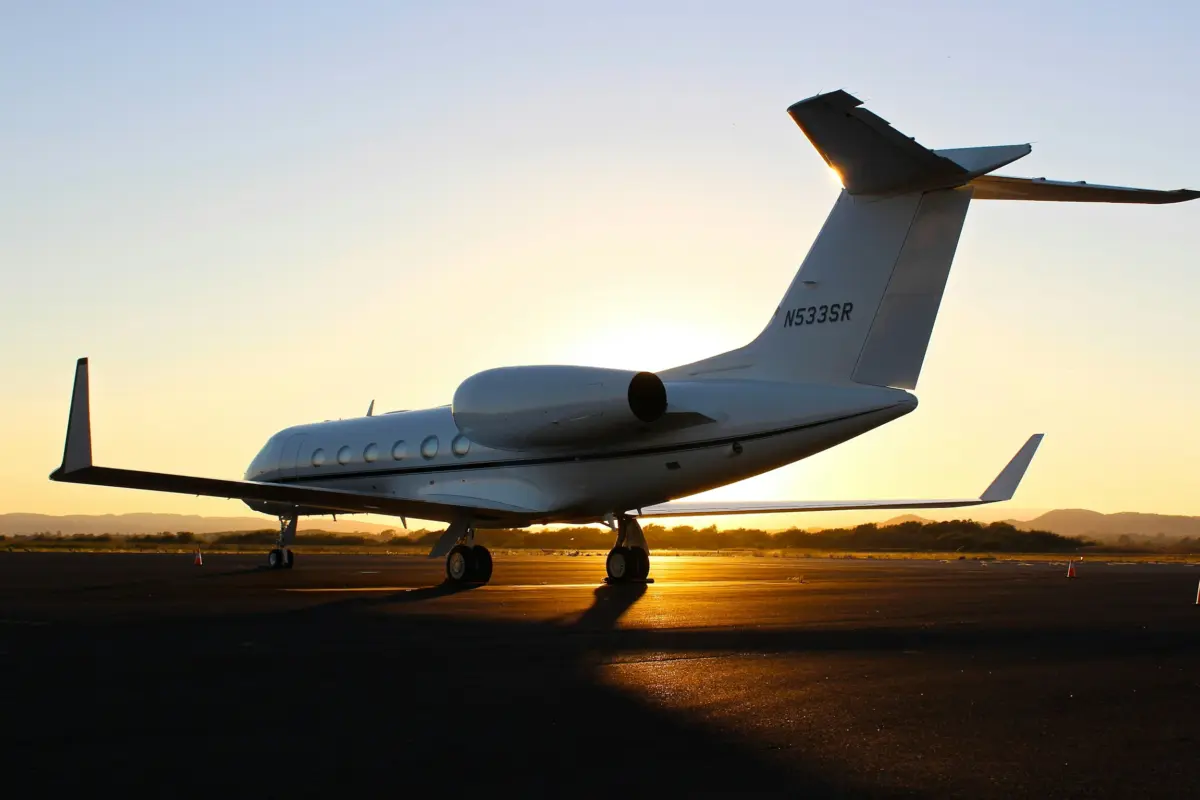 Business jet on the tarmac at sunset, ready for medical repatriation