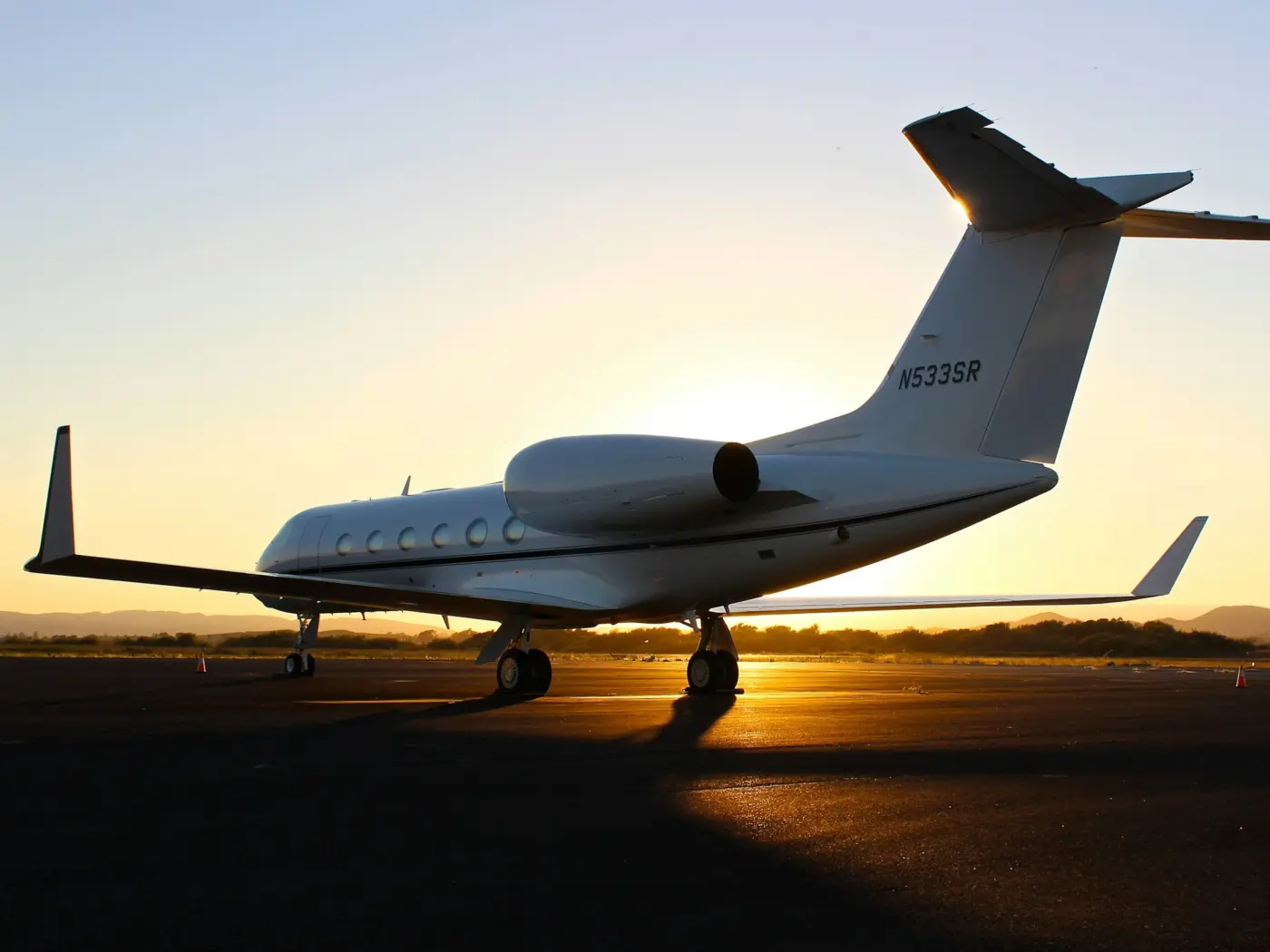 Business jet on the tarmac at sunset, ready for medical repatriation