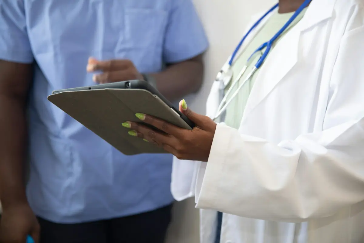 Healthcare professionals reviewing case information on a tablet