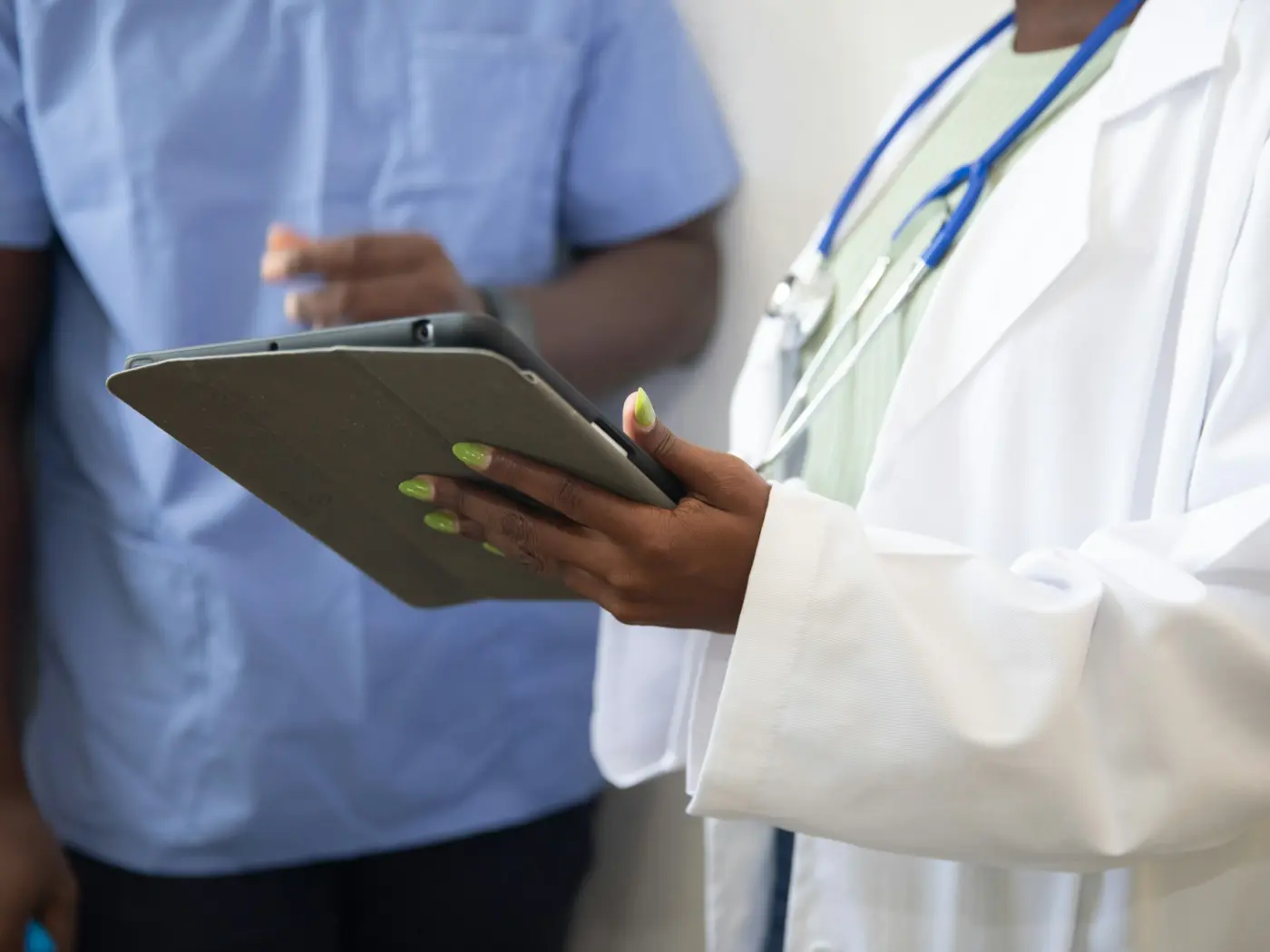 Healthcare professionals reviewing case information on a tablet
