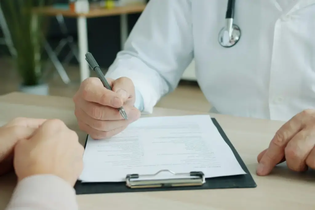 Doctor completing medical paperwork with a patient